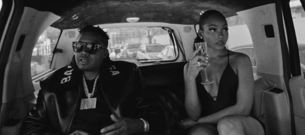 B&W thumbnail of Nas with a woman in the back seat of a limosine. Source: Nas' music video "Ugly."